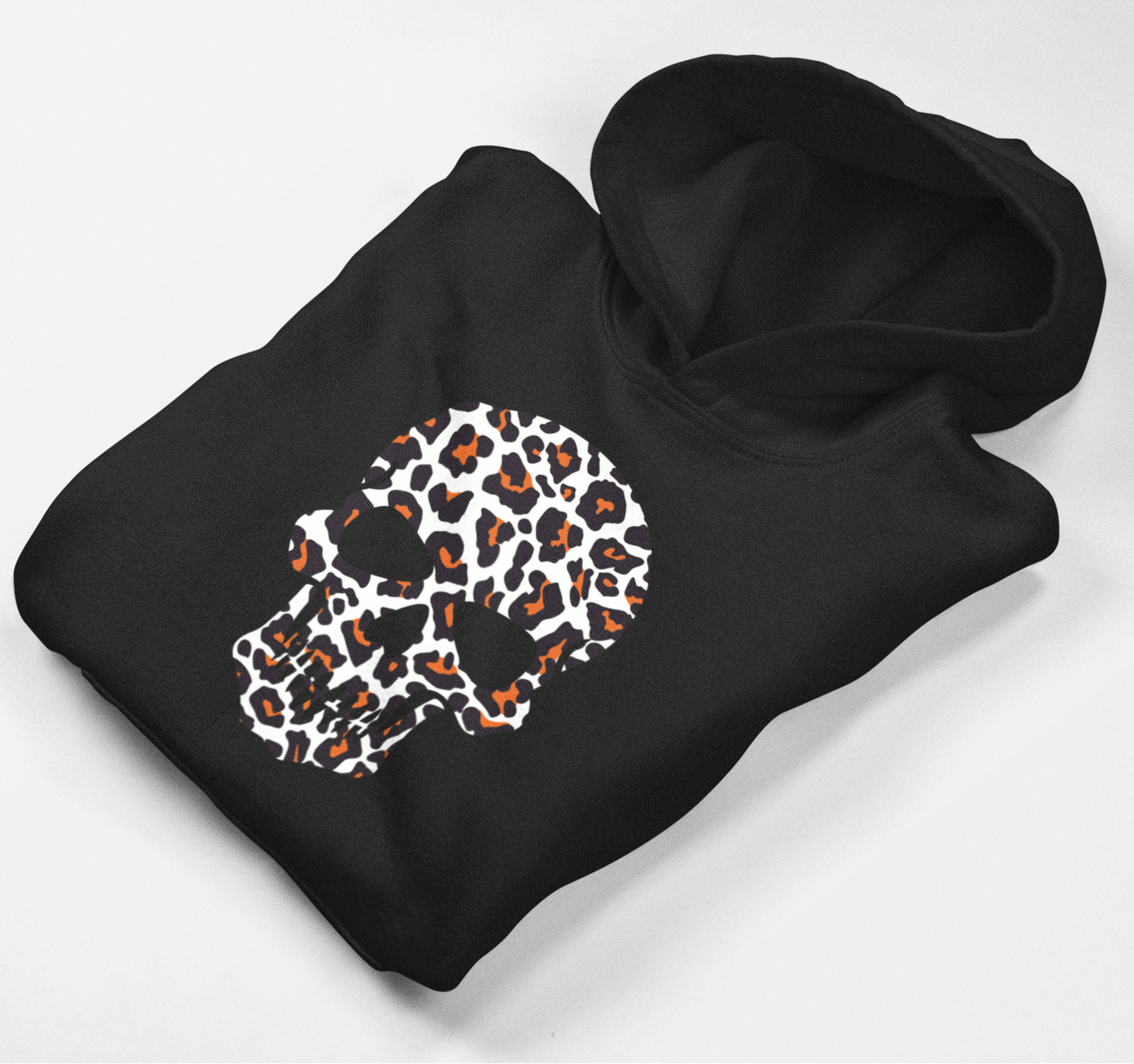 Folded black girls’ hoodie showing the orange, white and black leopard-print skull design.