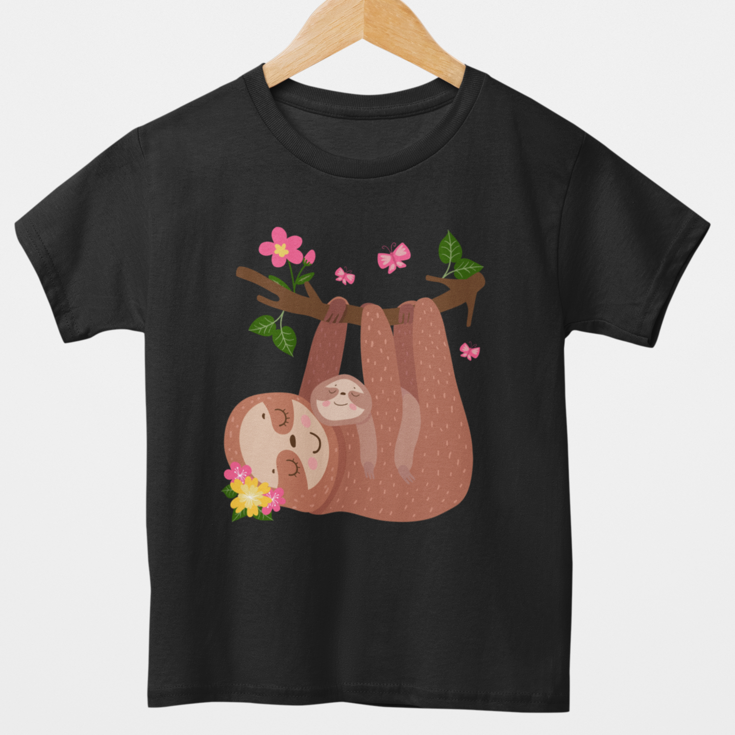 Girls black T-shirt featuring a sleepy mother sloth cuddling her baby while hanging from a flower-covered branch with pink butterflies.