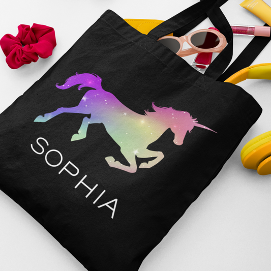 Kids black cotton tote bag featuring a personalised ombre unicorn design with the name “Sophia” printed beneath it.