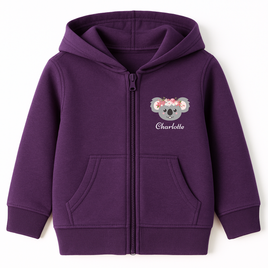 Girls purple zip hoodie featuring a cute grey koala face with a pink floral crown and custom name printed on the front left side.