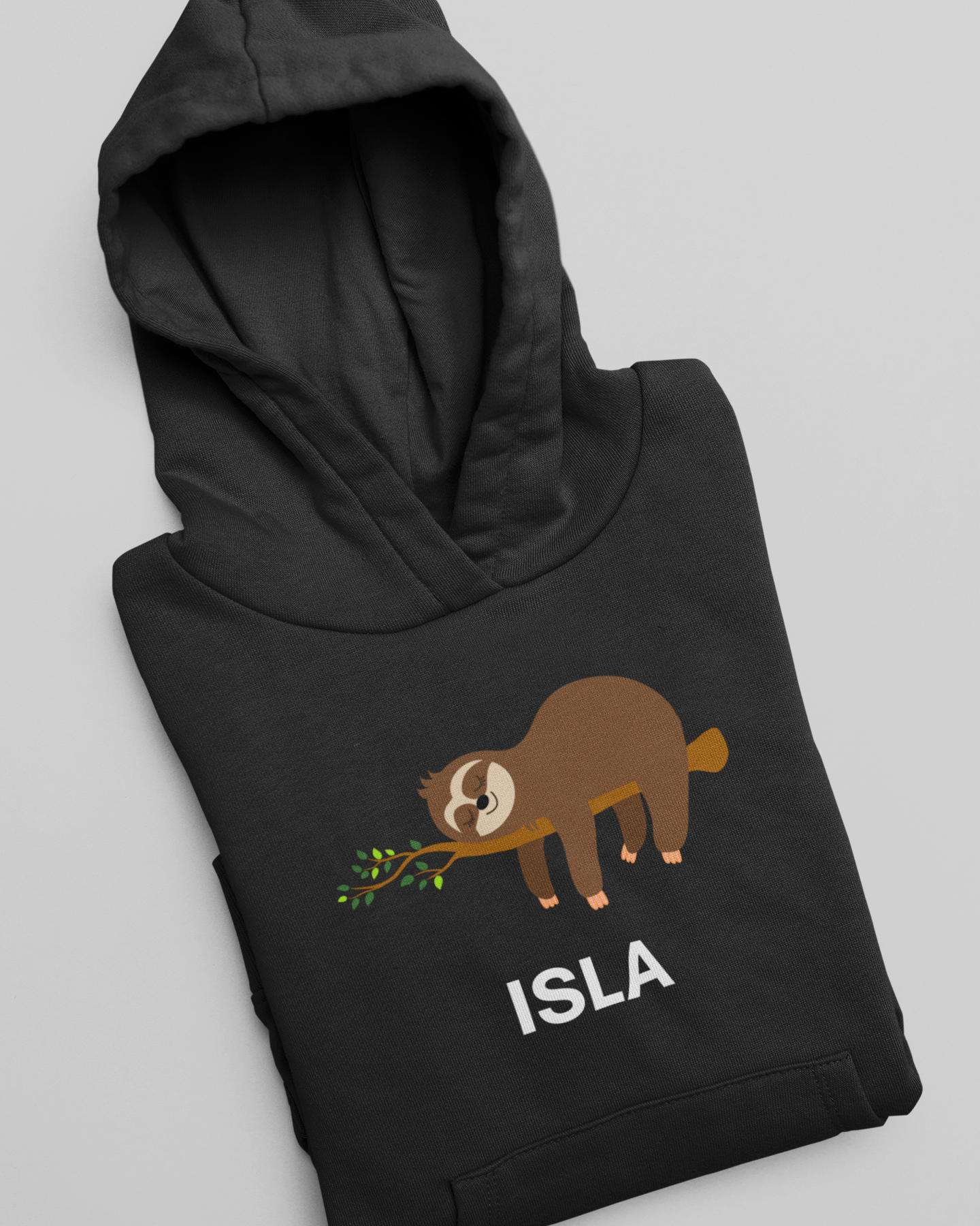 Folded black personalised kids sloth hoodie featuring a sleeping sloth on a branch and the name Isla printed underneath.