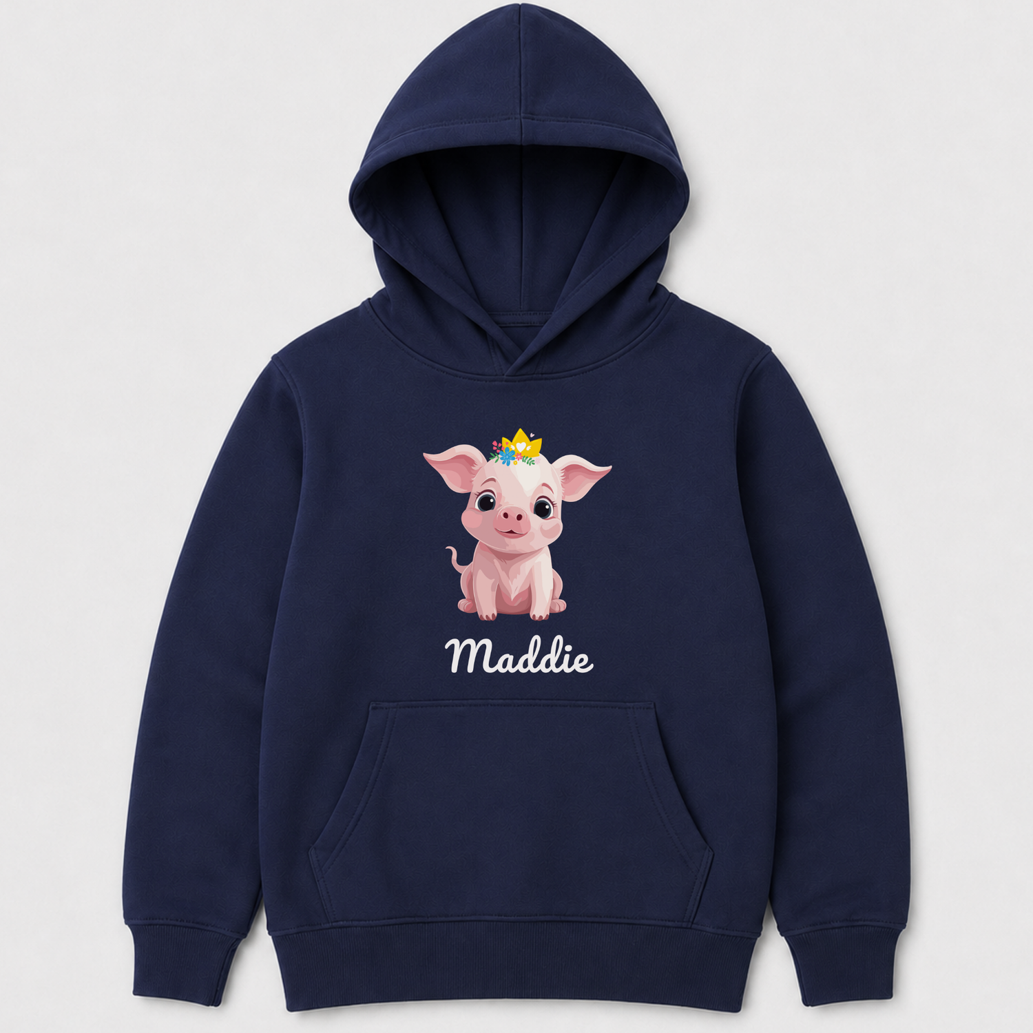 A navy blue kids pullover hoodie featuring a cartoon graphic of a pink pig wearing a small gold crown, with the name 'Maddie' printed in white script below. The hoodie is shown against a light gray background.