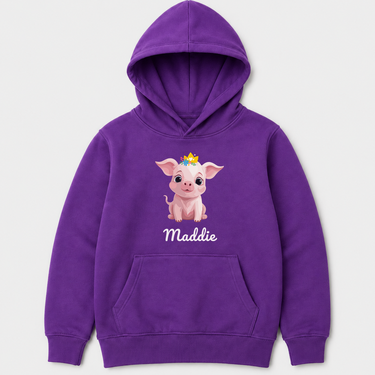 Children's purple pullover hoodie featuring a cartoon pig wearing a small yellow crown with the name 'Maddie' printed below in white script. The hoodie has a front kangaroo pocket and is shown against a light gray background.