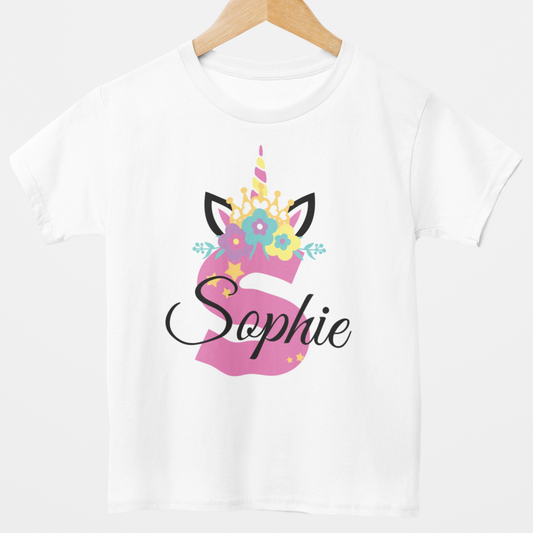 girls white cotton t-shirt featuring a pink unicorn horn and ears design with colourful floral crown and stars. Personalised with a large initial and custom name text.