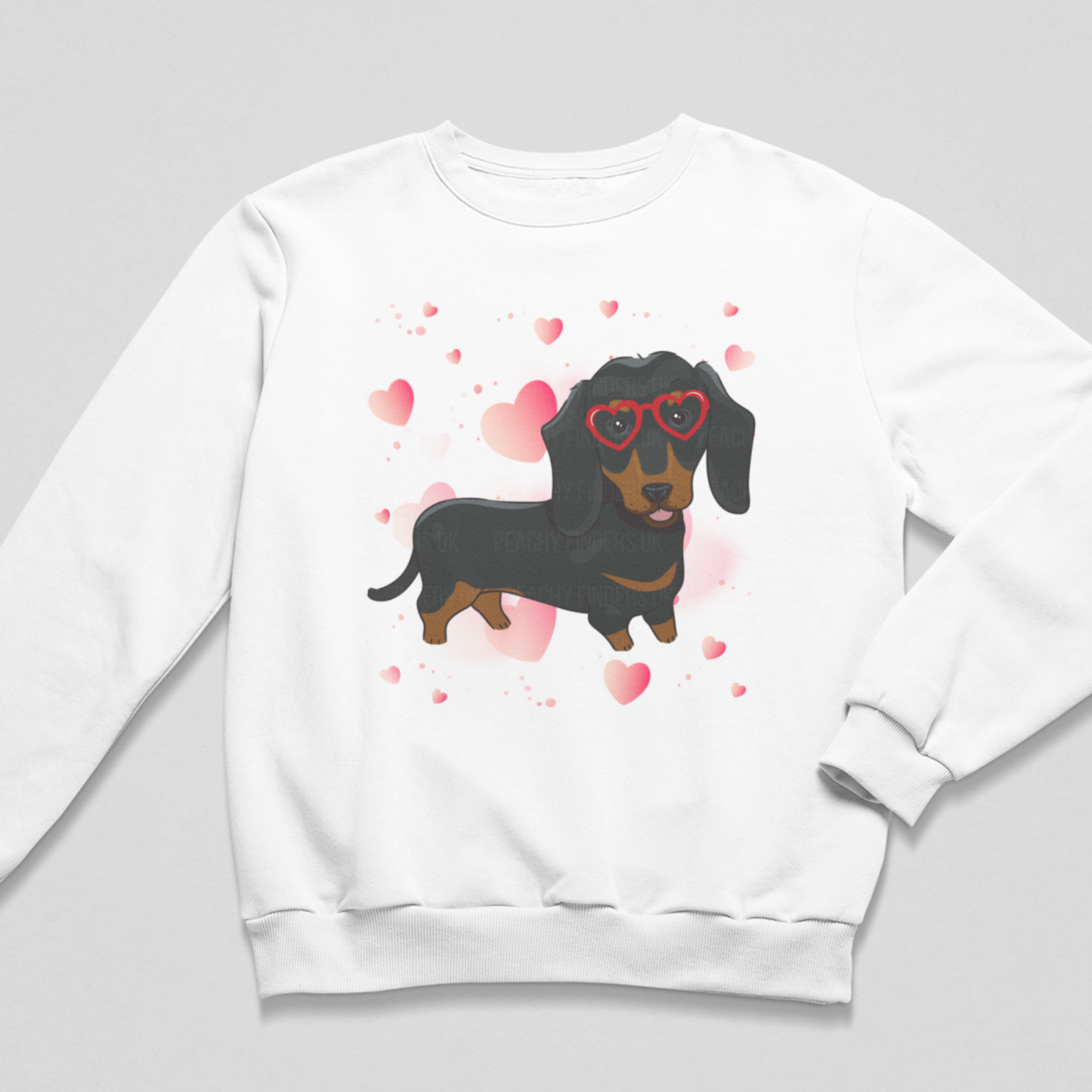 Girls sweatshirt in white featuring a cute Dachshund in red heart shaped glasses surrounded by hearts.