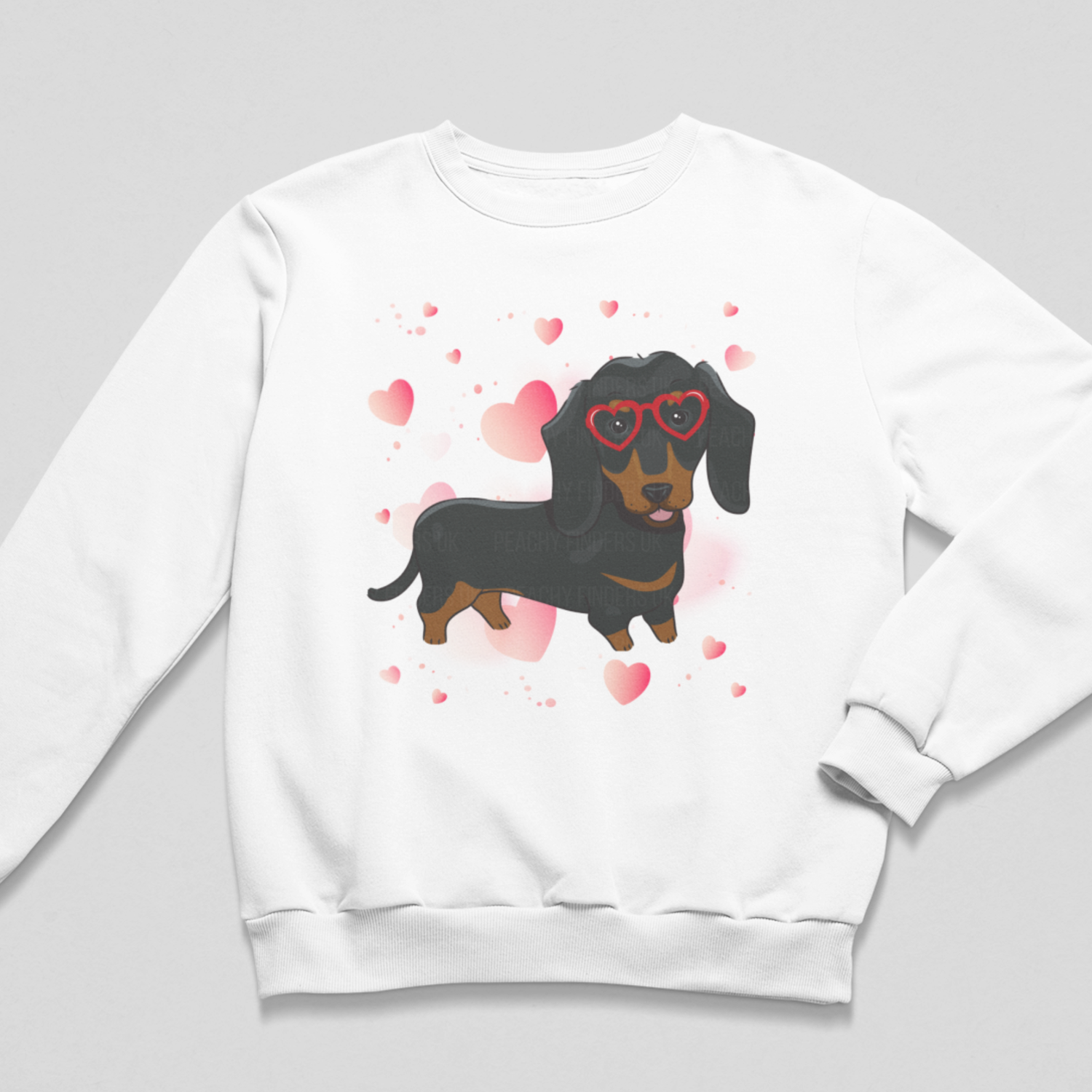 Girls sweatshirt in white featuring a cute Dachshund in red heart shaped glasses surrounded by hearts.