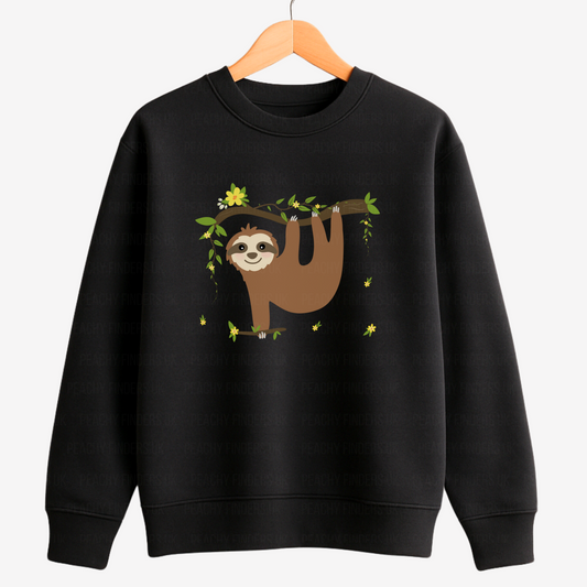 Kids black sweatshirt featuring a cute sloth hanging from a leafy branch with yellow flowers, designed for girls aged 3 to 13.