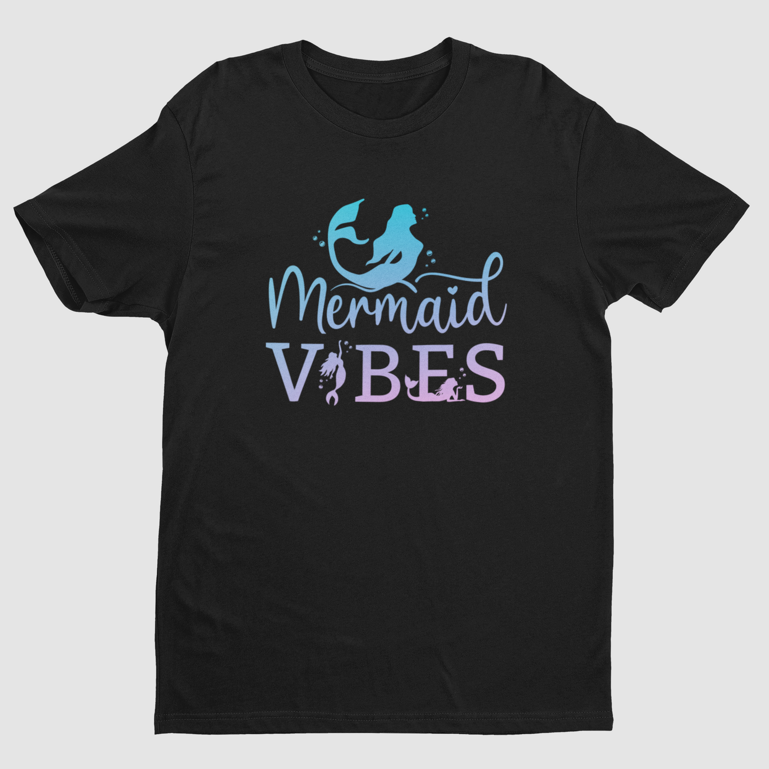 A black short-sleeve crewneck t-shirt featuring a 'Mermaid Vibes' graphic on the chest. The graphic includes a light blue mermaid silhouette and the words 'Mermaid VIBES' in a light blue and lavender-purple gradient font, set against a plain light gray background.
