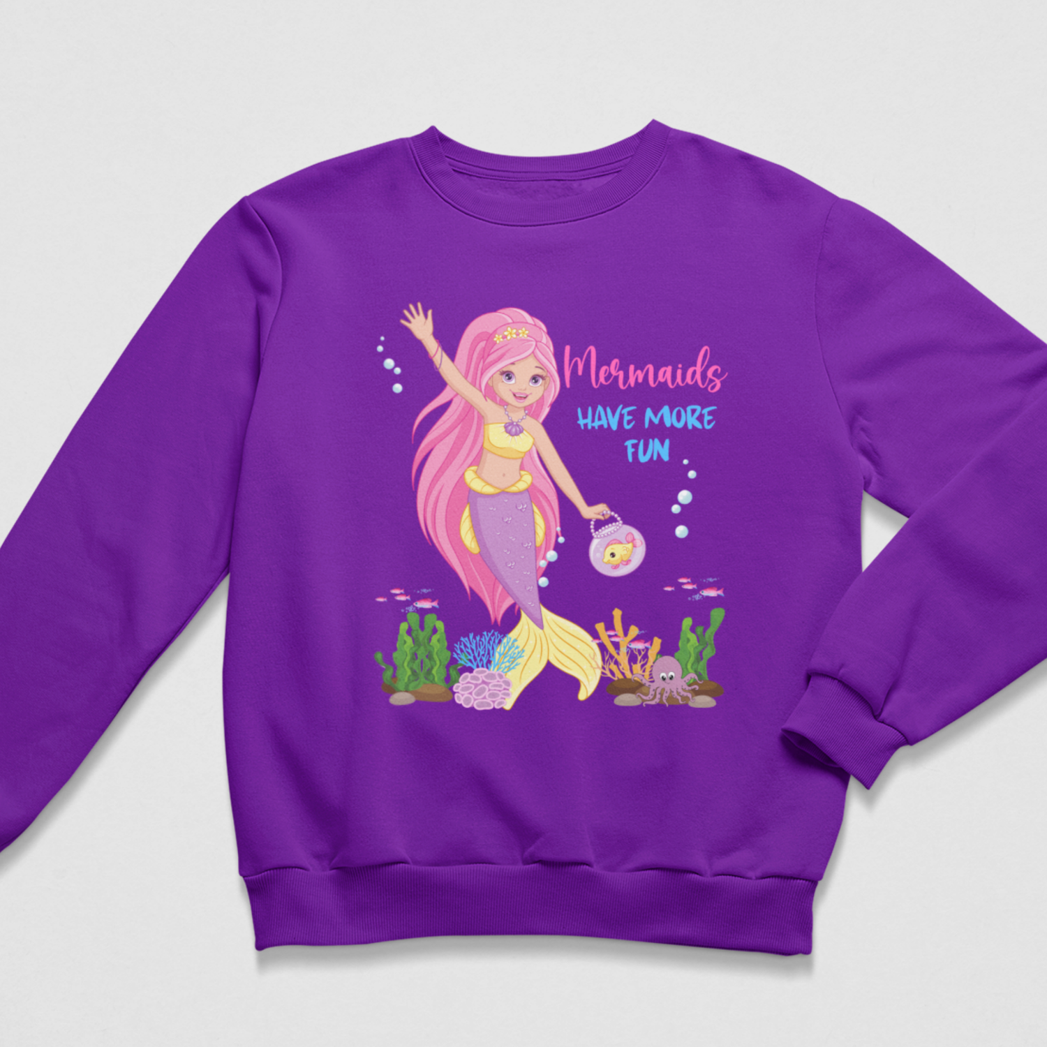 Girls’ purple sweatshirt featuring a pink-haired mermaid, colourful underwater scene and “Mermaids Have More Fun” wording.