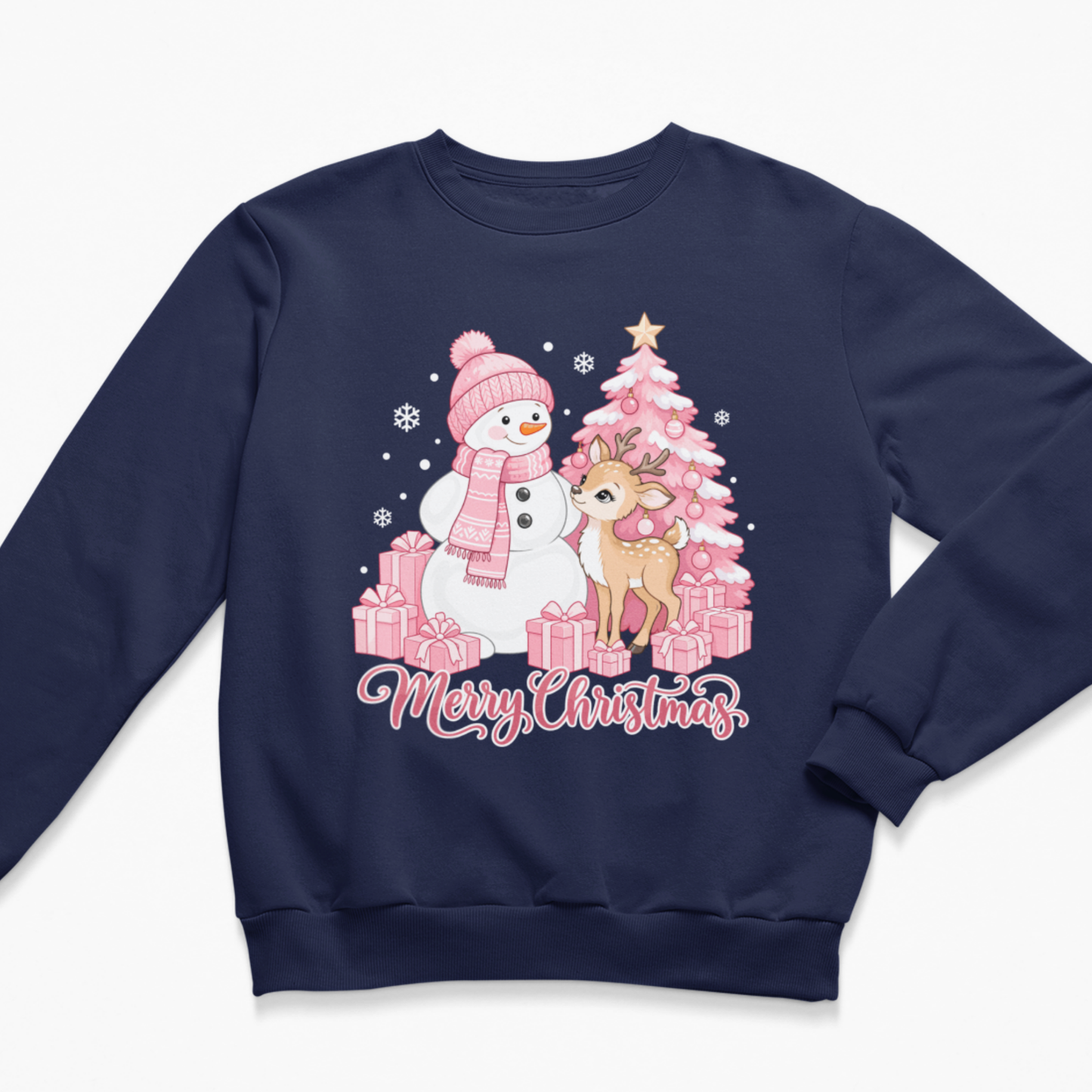 Flat lay of a navy blue kids' Christmas crewneck sweatshirt featuring a festive pink illustration of a snowman in a matching hat and scarf, a sweet baby deer, a pink decorated Christmas tree, wrapped gifts, and the script text "Merry Christmas"