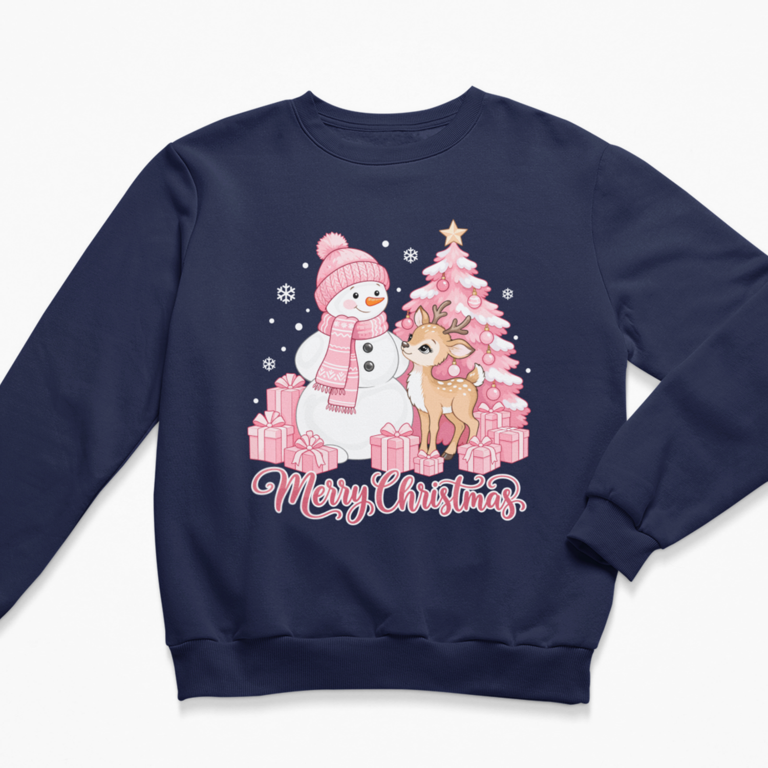 Flat lay of a navy blue kids' Christmas crewneck sweatshirt featuring a festive pink illustration of a snowman in a matching hat and scarf, a sweet baby deer, a pink decorated Christmas tree, wrapped gifts, and the script text "Merry Christmas"
