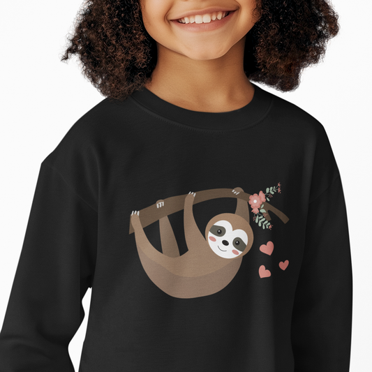 Young girl wearing a black sweatshirt featuring an adorable sloth hanging from a flower-decorated branch with pink hearts, displayed flat on a white background.