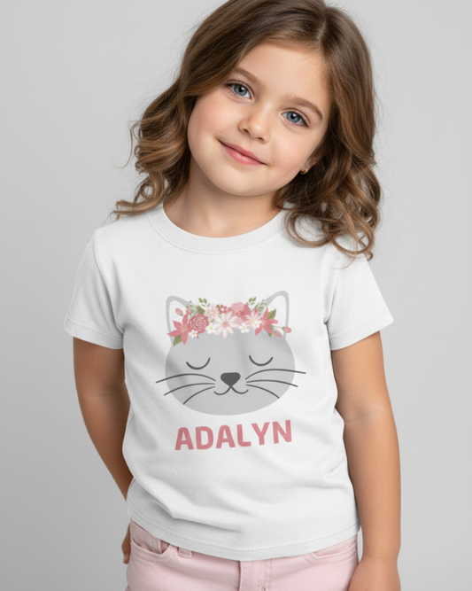 Girl modelling personalised floral cat face t-shirt with custom name Adalyn, white kids graphic tee in studio