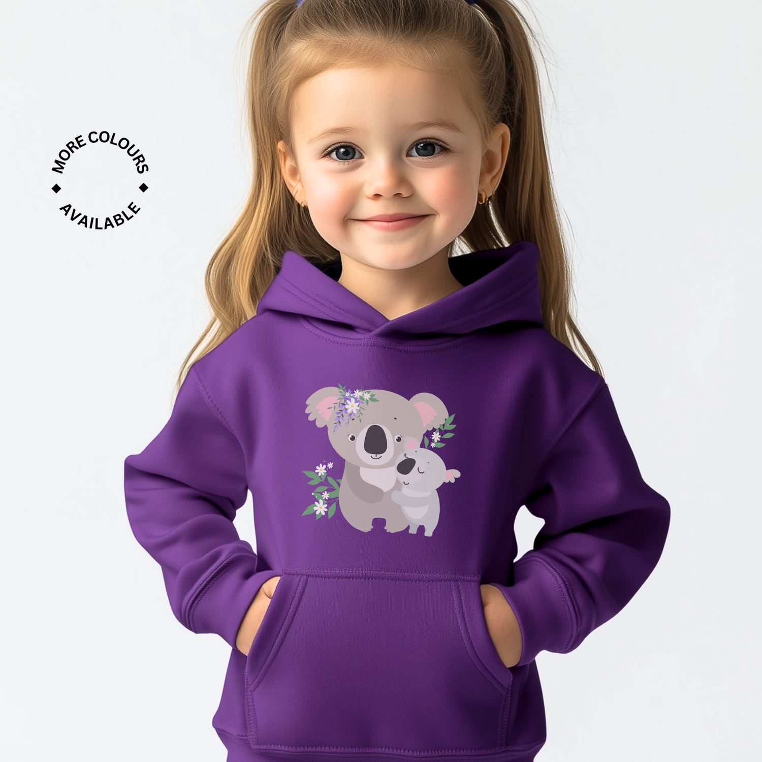 Young girl wearing a purple pullover hoodie featuring a cute mummy and baby koala illustration with floral accents