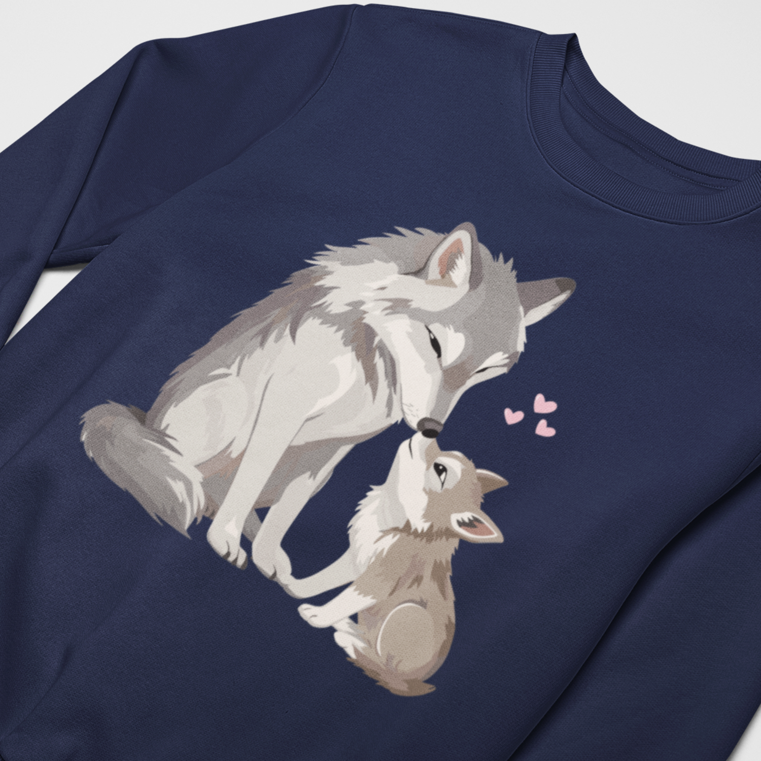 Girls navy sweatshirt featuring a mum and baby wolf illustration and cute pink hearts- flat lay.