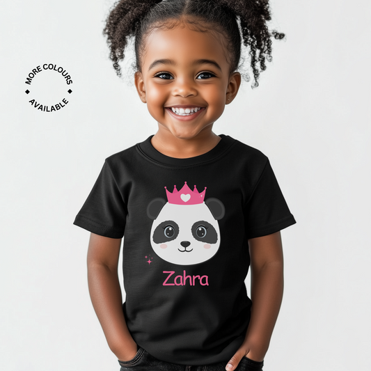 A young girl smiling and wearing a black t-shirt with a cute panda design and the name 'Zahra' printed on the front.