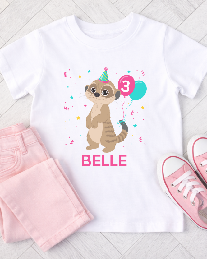Girls personalised meerkat birthday t-shirt with name and age, styled outfit flat lay with pink jeans and trainers