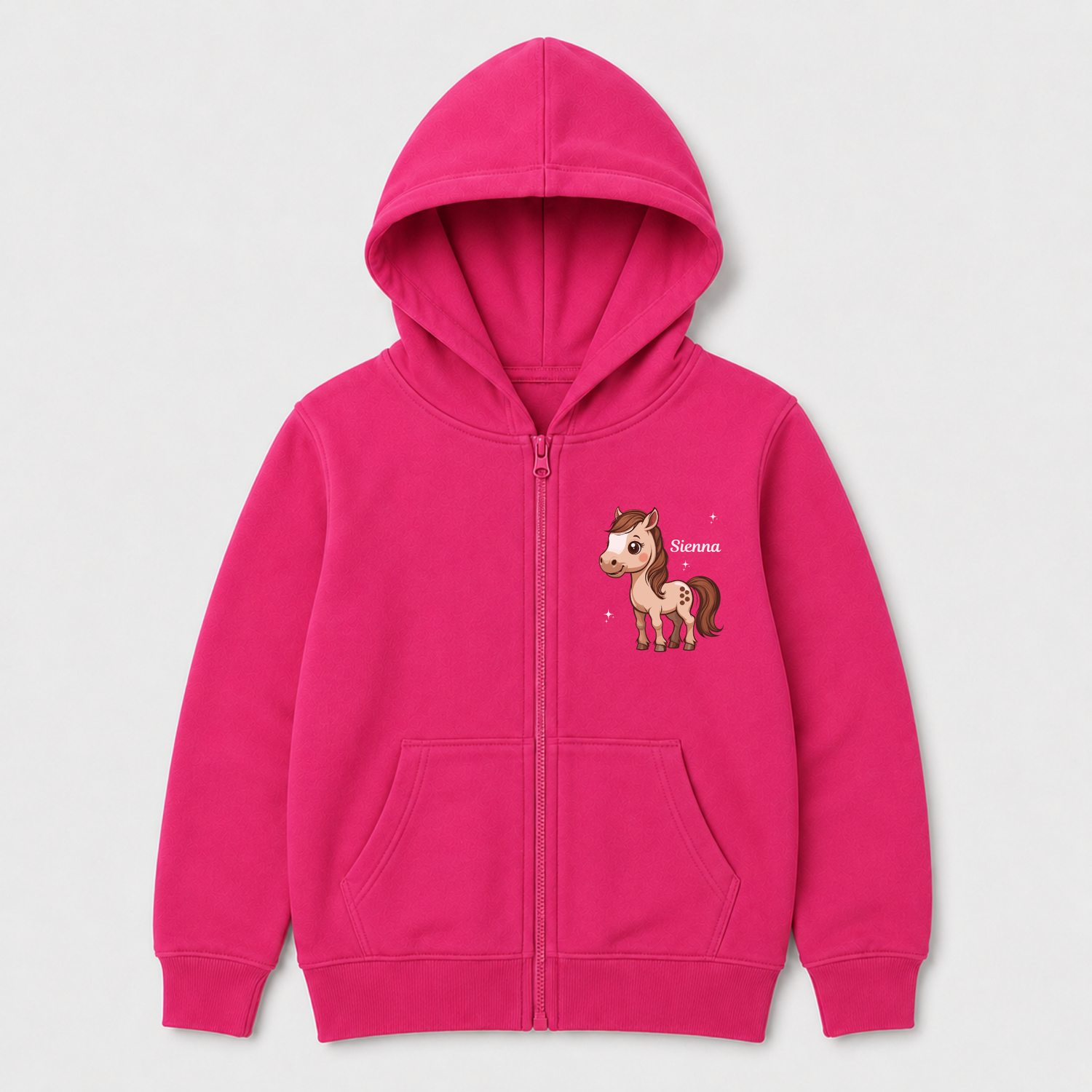 A pink zip-up hoodie for kids, featuring a cartoon horse graphic on the left chest with the name 'Sienna' printed next to it. The hoodie has a front zipper, a hood, and two front kangaroo pockets, shown against a light grey background.