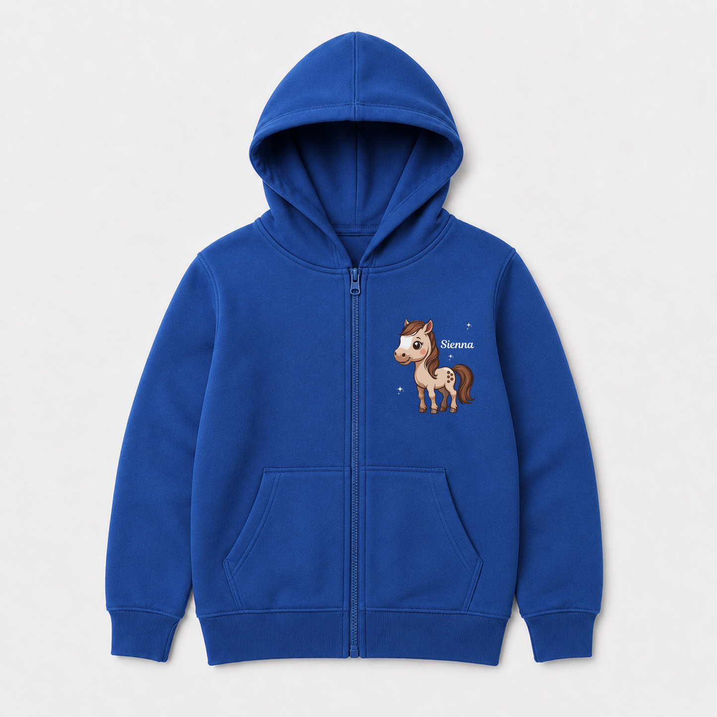 A kids royal blue zip-up hoodie with a front pocket, featuring a cartoon horse graphic on the left chest with the name 'Sienna' written next to it, shown on a light grey background.
