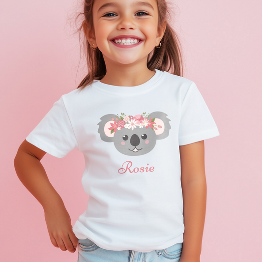 Girl wearing personalised white t-shirt with floral koala graphic and custom name