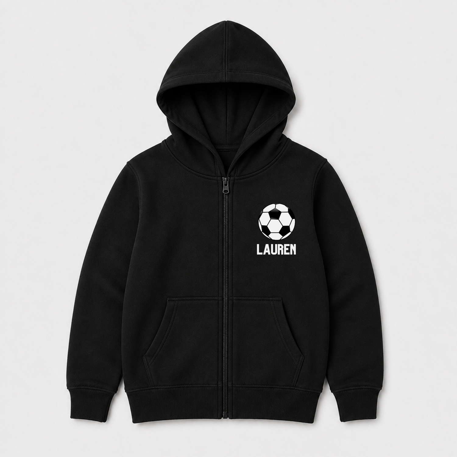 Girls black zip-up hoodie with a white soccer ball graphic and the name 'LAUREN' printed on the left chest, displayed on a light grey background.