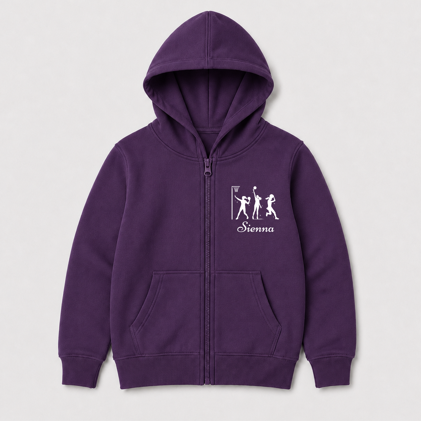 Purple girls’ netball hoodie laid flat, showing the full zip, front pockets and personalised white chest print.