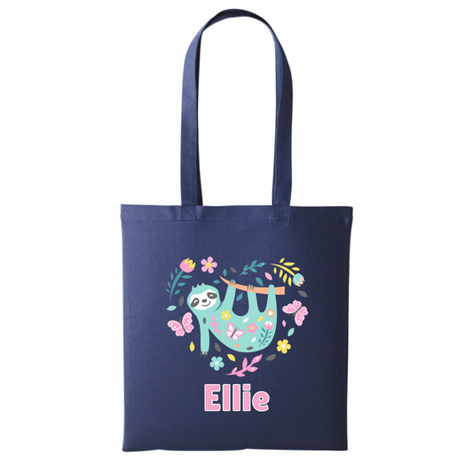 Girls navy cotton tote bag with a printed design of a colourful sloth, flowers, and butterflies. Custom-name 'Ellie' printed in pink and white underneath