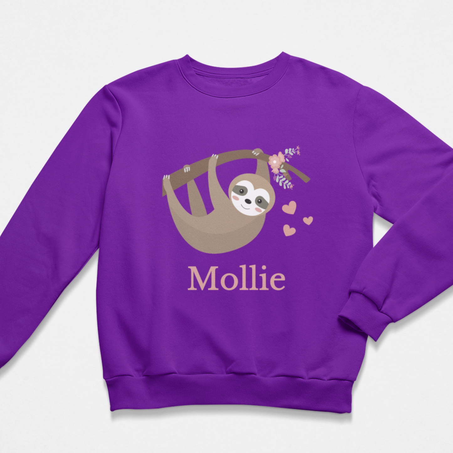 A kids purple crewneck sweatshirt featuring a cartoon sloth hanging in a tree branch with small pink hearts and the name 'Mollie' printed below in pink, shown on a light grey background.