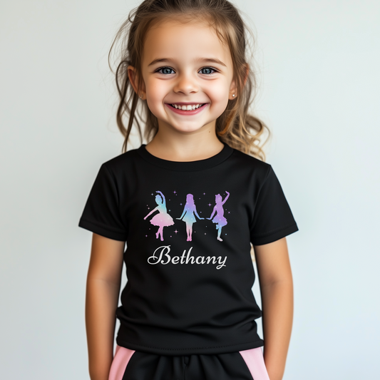 Little girl wearing a black girls dance t-shirt featuring three colourful dancer silhouettes and the name “Bethany” printed on the front.