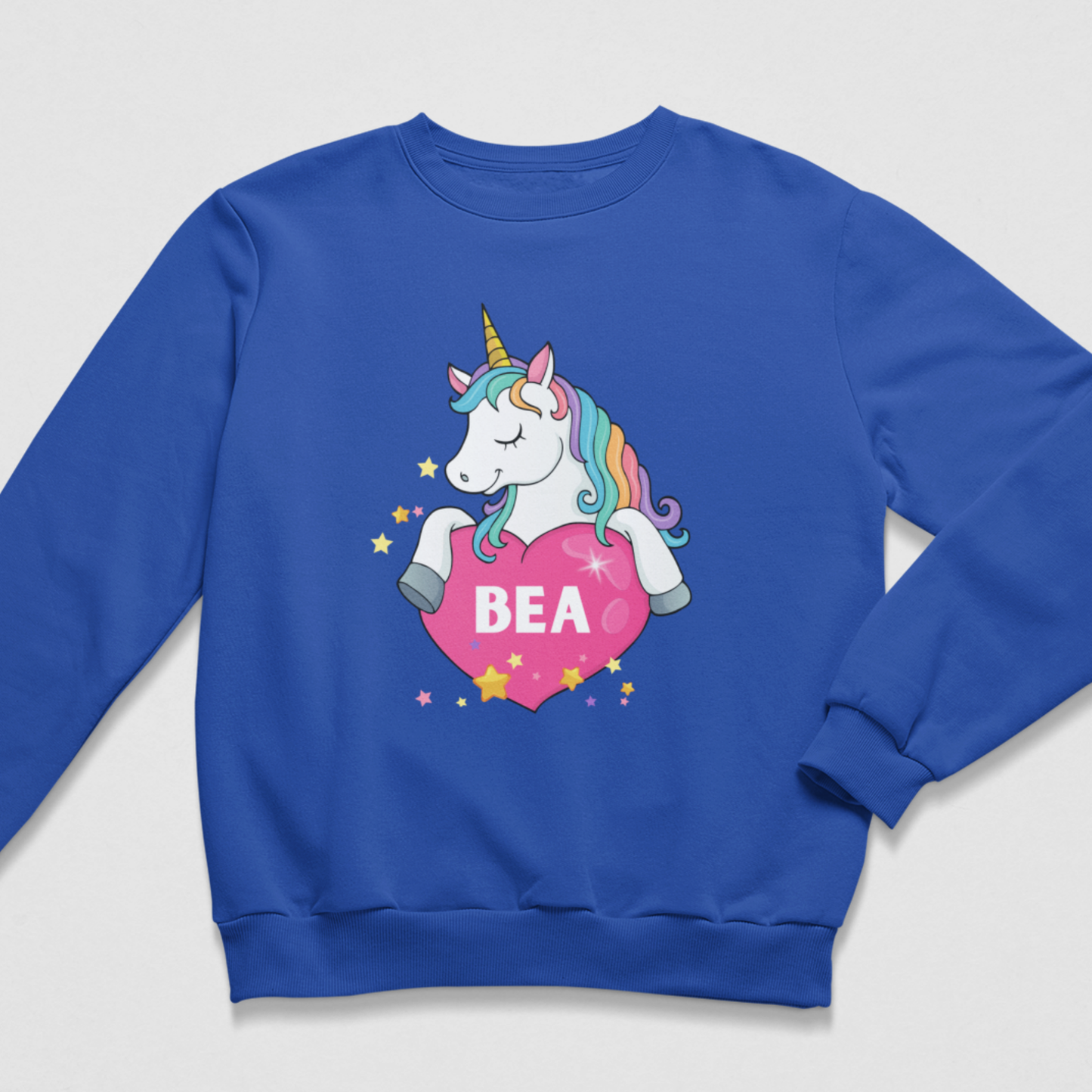 Girls’ royal-blue personalised sweatshirt featuring a rainbow-maned unicorn, pink heart, stars and the name Bea.