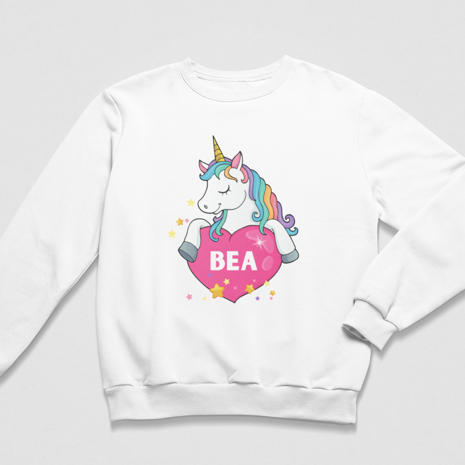 Girls’ white personalised sweatshirt with a colourful unicorn, pink heart, scattered stars and the name Bea.