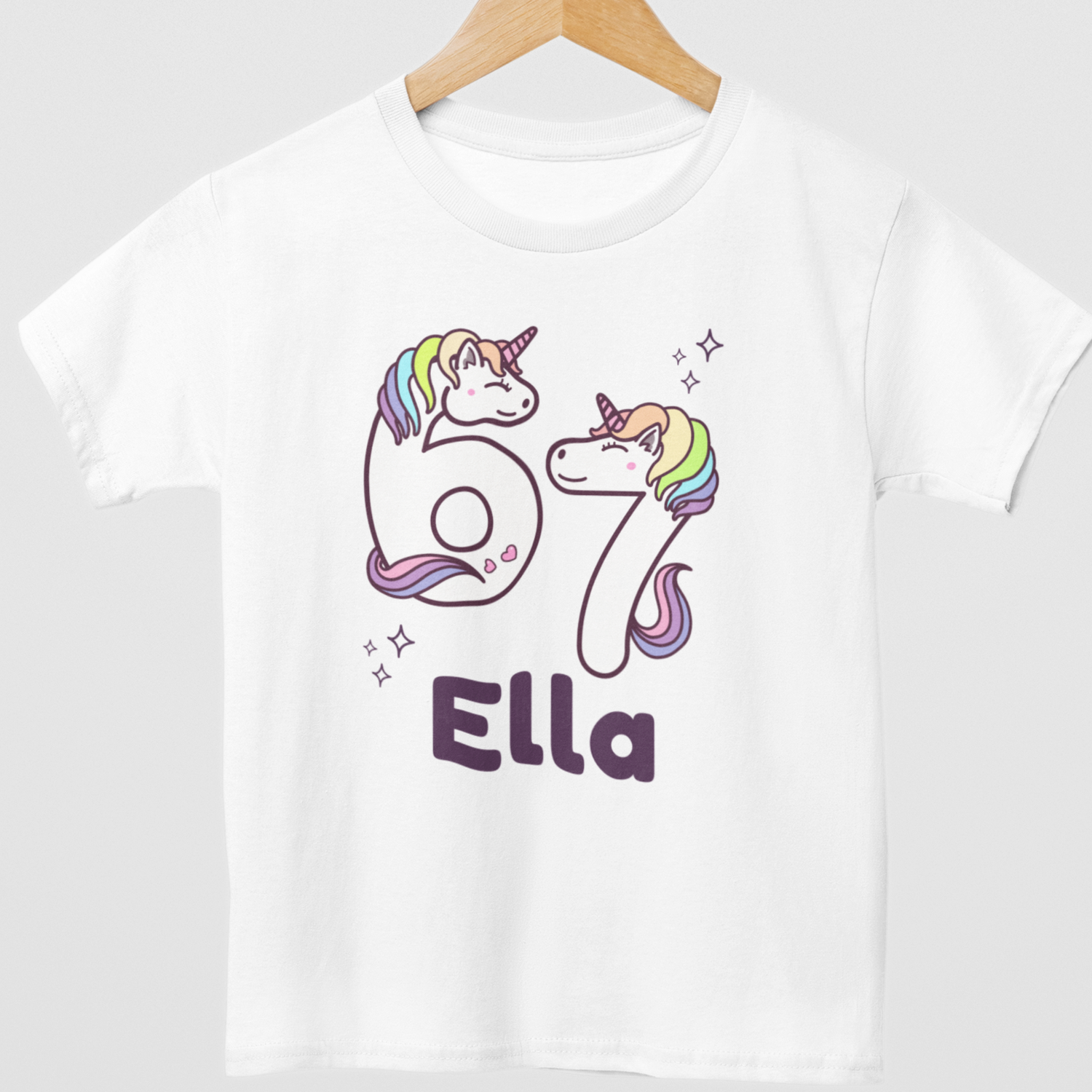 Girls personalised Six Seven unicorn numbers t-shirt with custom name Ella on hanger