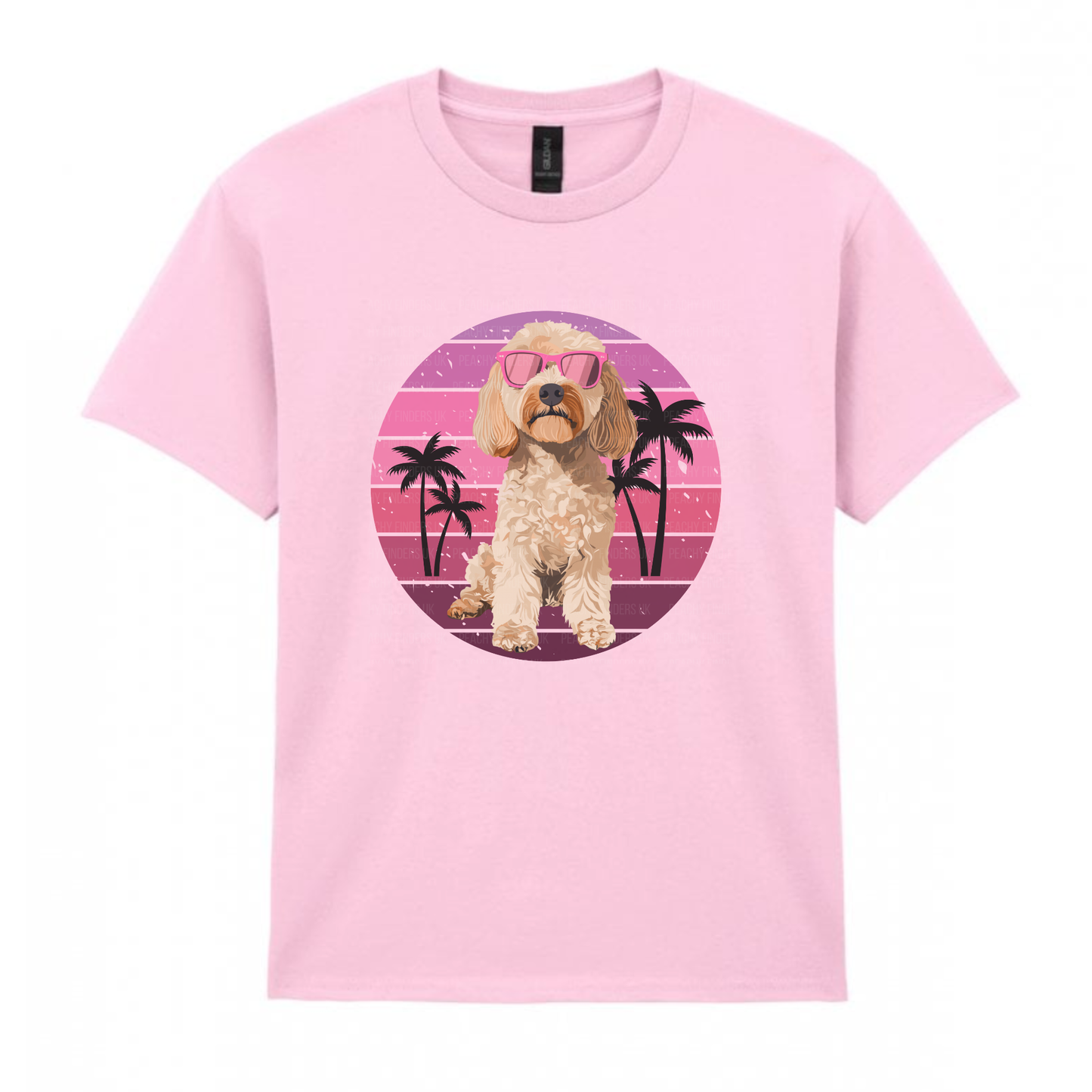 Kids soft pink t-shirt with a cockapoo dog graphic on a pink and purple circular design with palm trees.