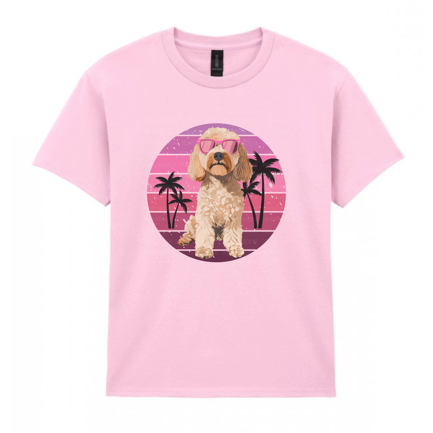 Kids soft pink t-shirt with a cockapoo dog graphic on a pink and purple circular design with palm trees.