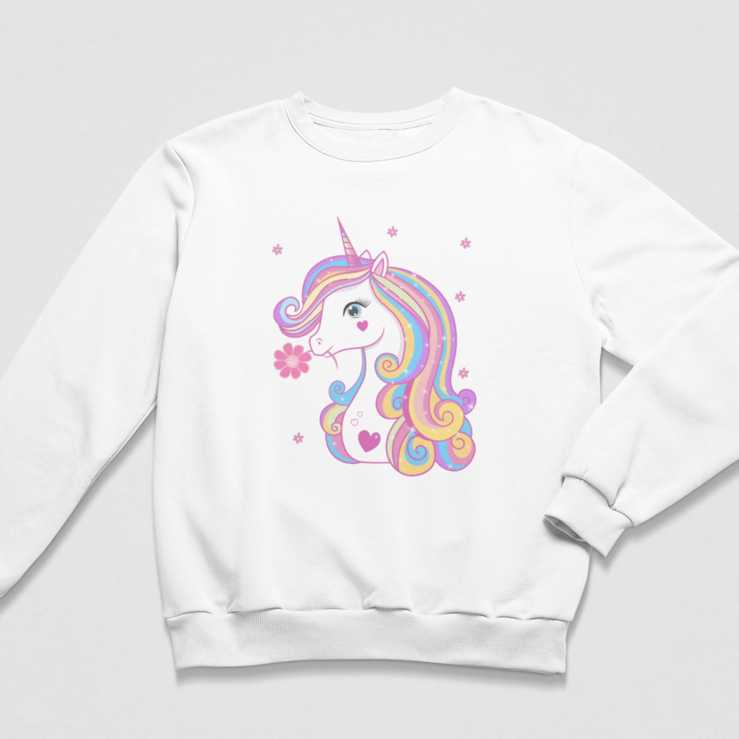 A girls white crewneck sweatshirt featuring a colourful pastel unicorn graphic on the front, set against a light grey background.