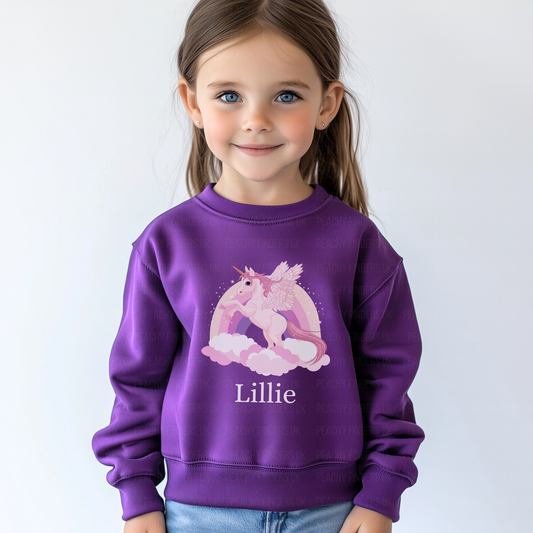 Child wearing a purple sweatshirt with a unicorn design and the name 'Lillie'.