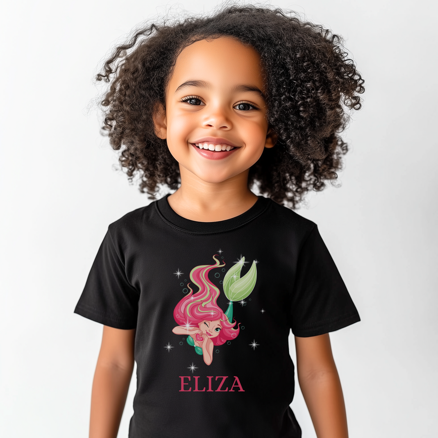 A girl wearing a black t-shirt with a mermaid graphic and the name 'ELIZA' printed below the design.