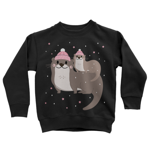 Kids black sweatshirt with mum and baby winter otters wearing pink hats, snow and star graphic front view