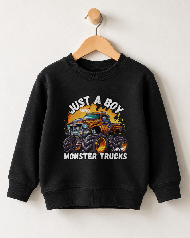 Kids monster truck sweatshirt in black hanging on a wooden hanger with "Just A Boy Who Loves Monster Trucks" graphic printed on the front.
