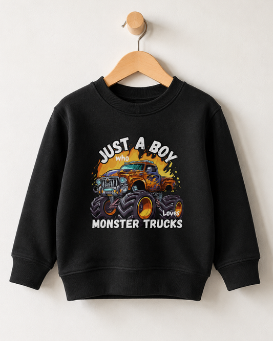 Kids monster truck sweatshirt in black hanging on a wooden hanger with "Just A Boy Who Loves Monster Trucks" graphic printed on the front.