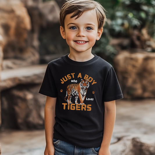 Smiling young boy wearing a black T-shirt with “Just a Boy Who Loves Tigers” design featuring a tiger illustration, standing outdoors.