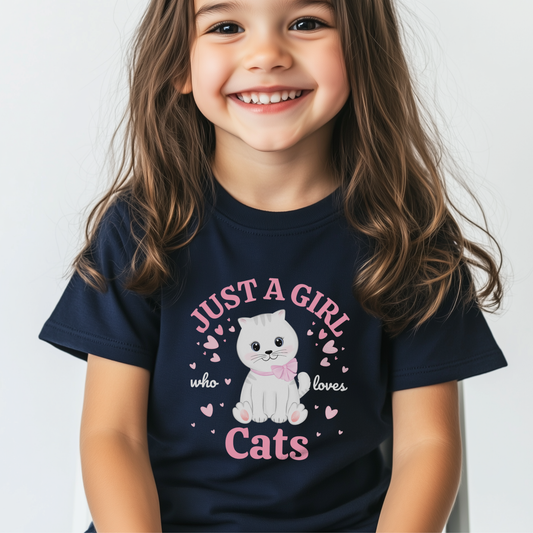 Young girl models a navy cotton t-shirt featuring a cute white kitten with pink bow surrounded by hearts and arched pink text ‘Just a Girl Who Loves Cats’