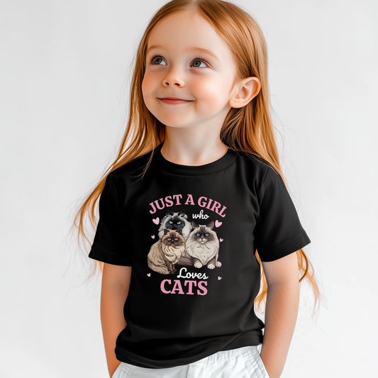 Little girl modelling a black t-shirt featuring three fluffy Ragdoll and Persian cats surrounded by pink hearts and the text ‘Just a Girl Who Loves Cats’