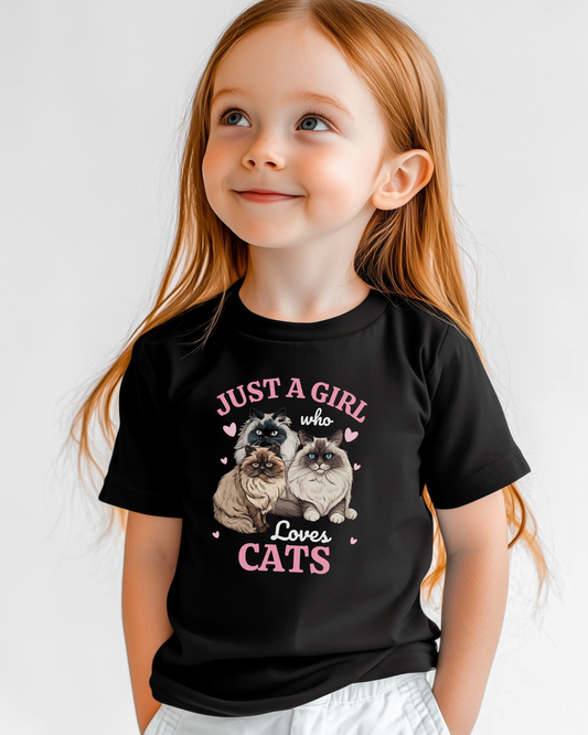 Little girl modelling a black t-shirt featuring three fluffy Ragdoll and Persian cats surrounded by pink hearts and the text ‘Just a Girl Who Loves Cats’