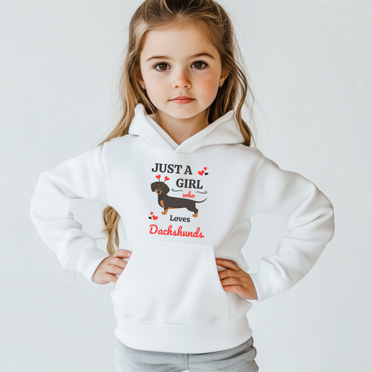 A girl wearing a white pullover hoodie with the text 'JUST A GIRL who loves Dachshunds' and an illustration of a Dachshund.