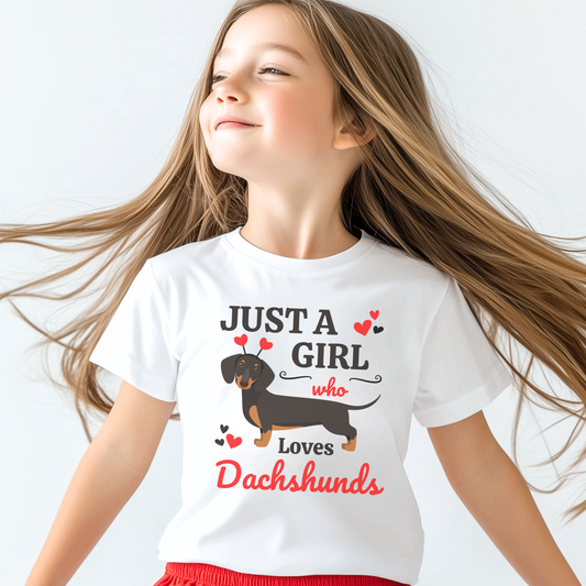 Smiling girl wearing a white “Just a Girl Who Loves Dachshunds” T-shirt with a cute dachshund and red hearts on the front
