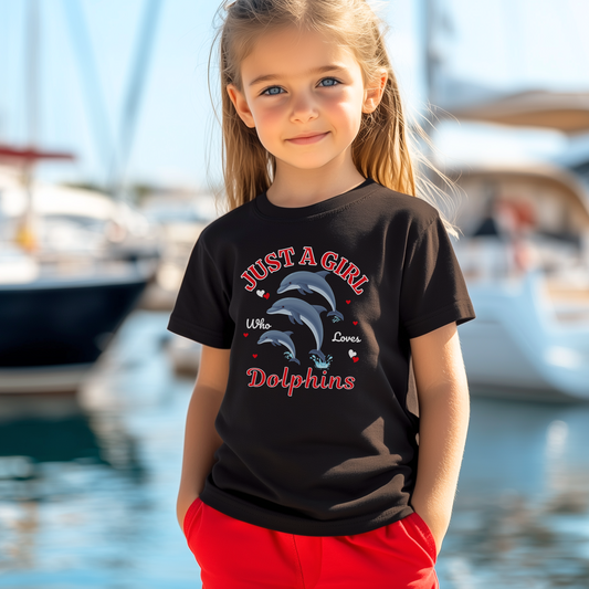 A girl standing at a boat marina wearing a Dolphin graphic t-shirt