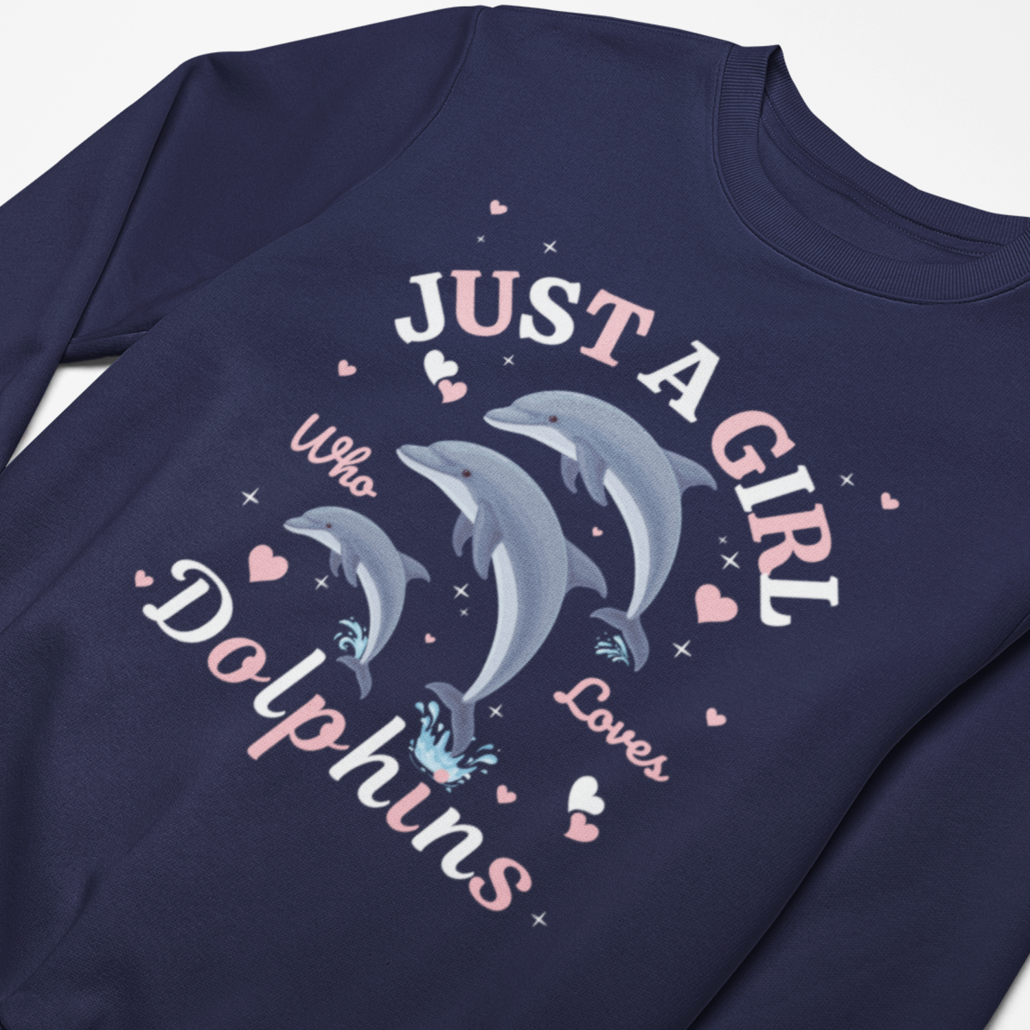Close-up of girls navy sweatshirt with three playful dolphins, hearts and the slogan Just a Girl Who Loves Dolphins printed on the front.