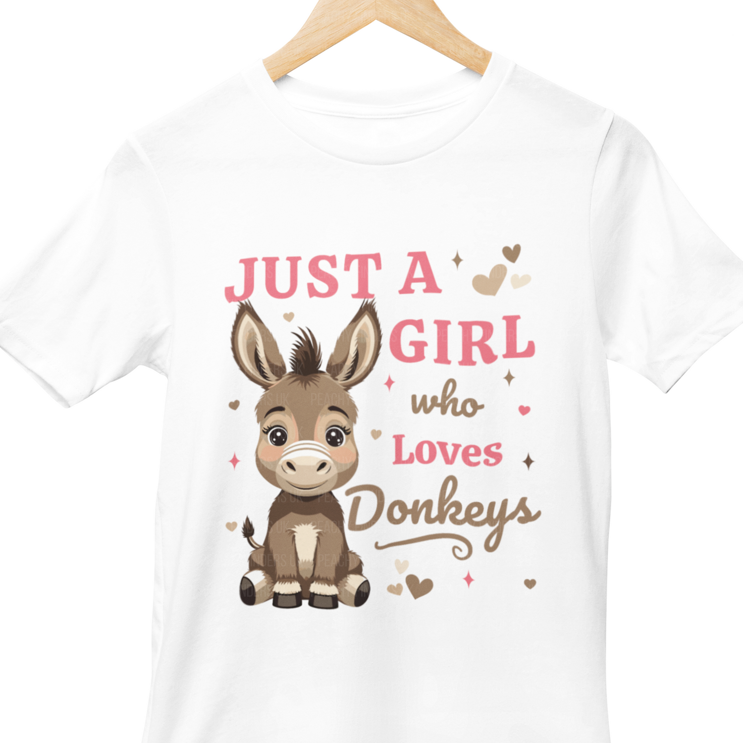 Kids white t-shirt with a cartoon donkey and 'just a girl who loves donkeys' on a wooden hanger