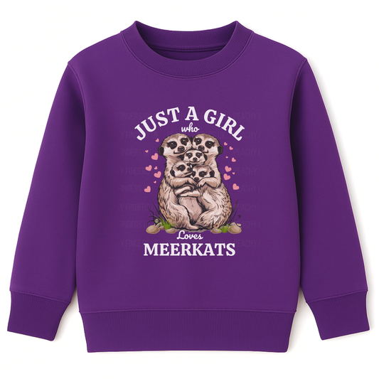 Girls purple sweatshirt with “Just a Girl Who Loves Meerkats” text and cute meerkat family graphic surrounded by pink hearts, flat lay on white background.